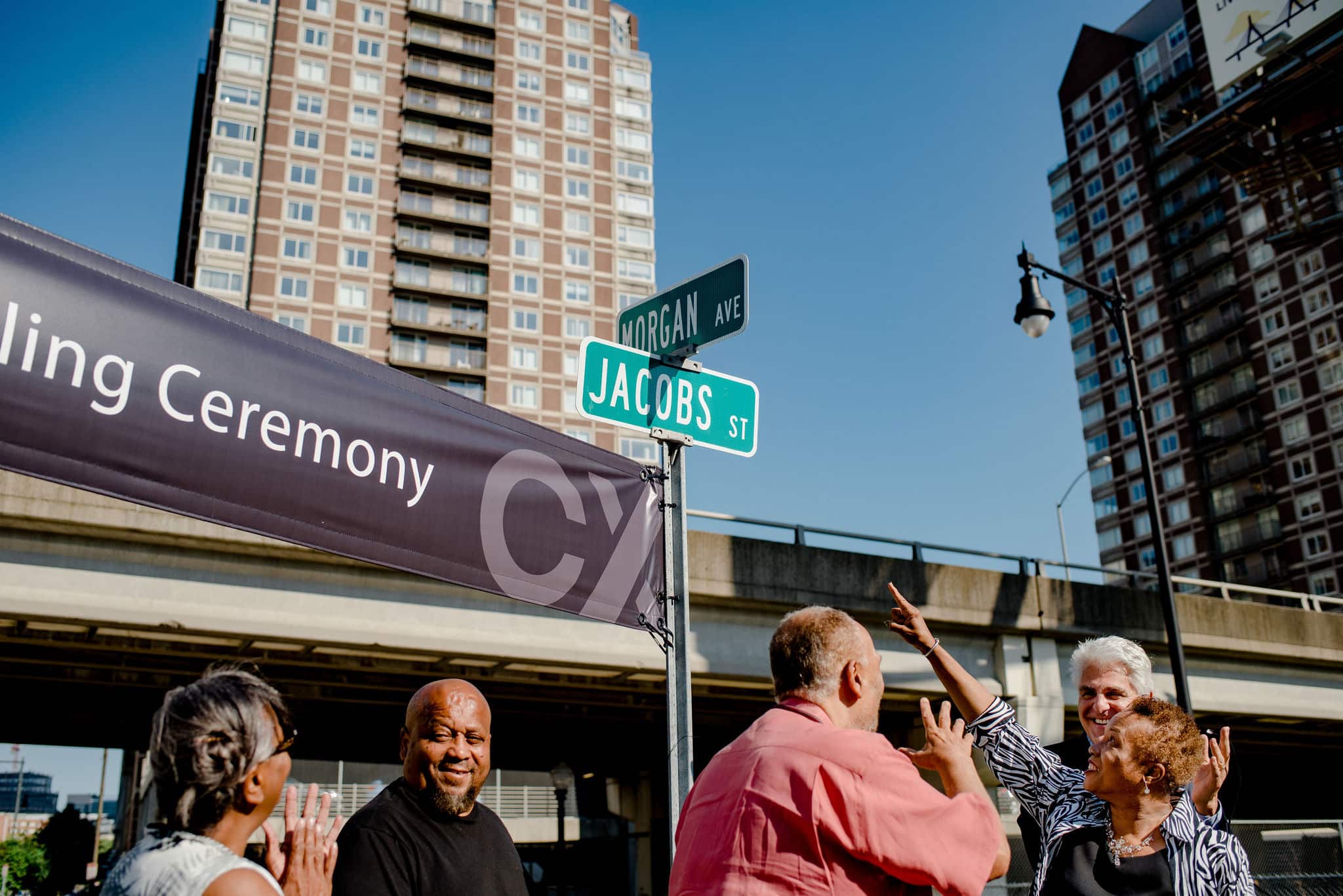 Community celebrates newly revealed Morgan Avenue and Jacobs Street signs at city corner