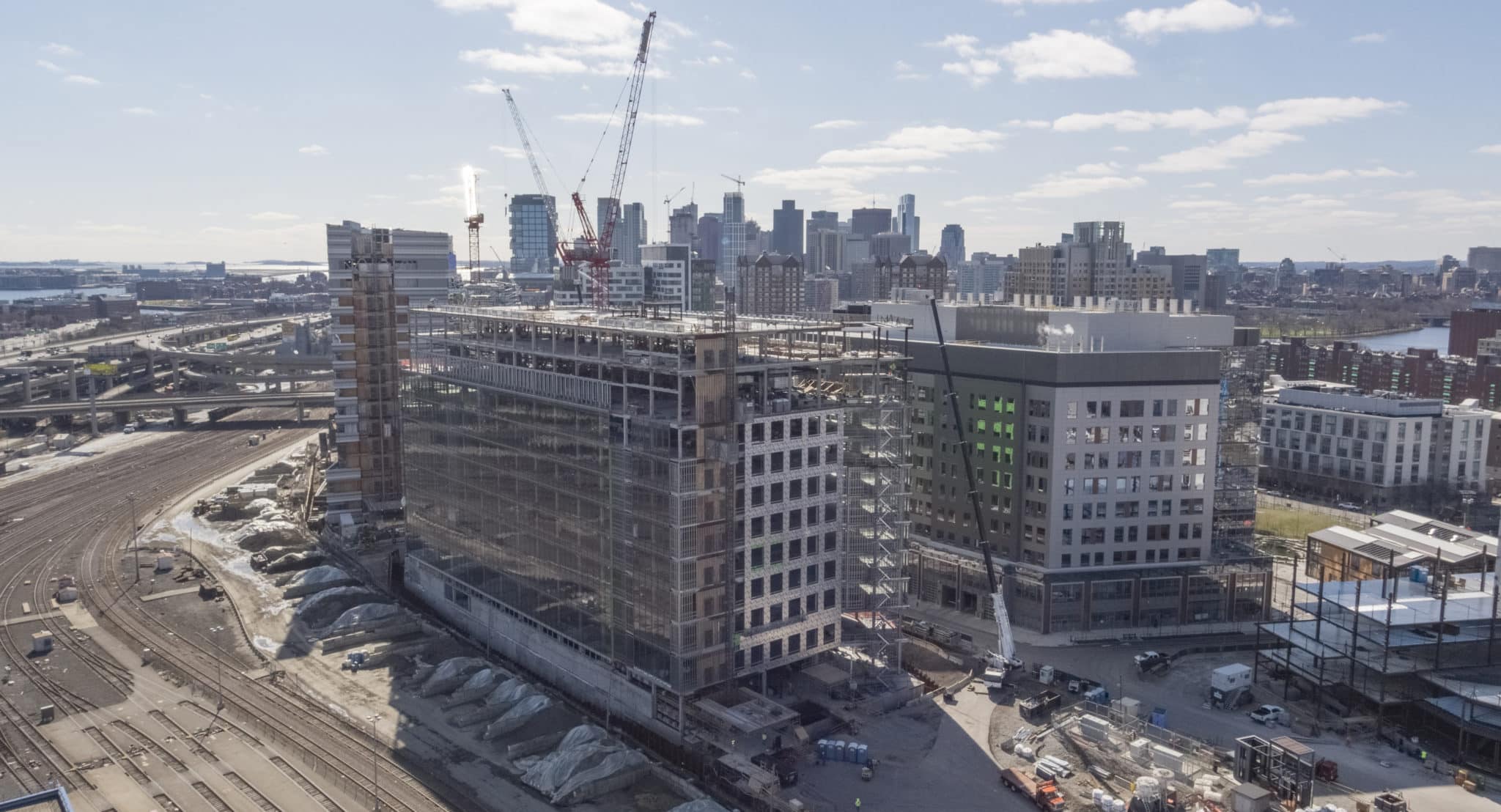 Mid-construction Park 151 building featuring exposed steel framework and green sheathing panels