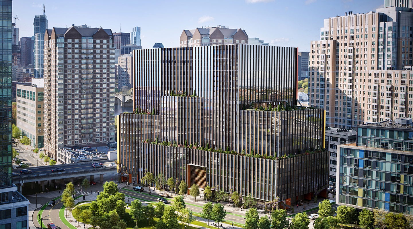 Urban commercial development featuring stepped-back glass facade and rooftop garden terraces