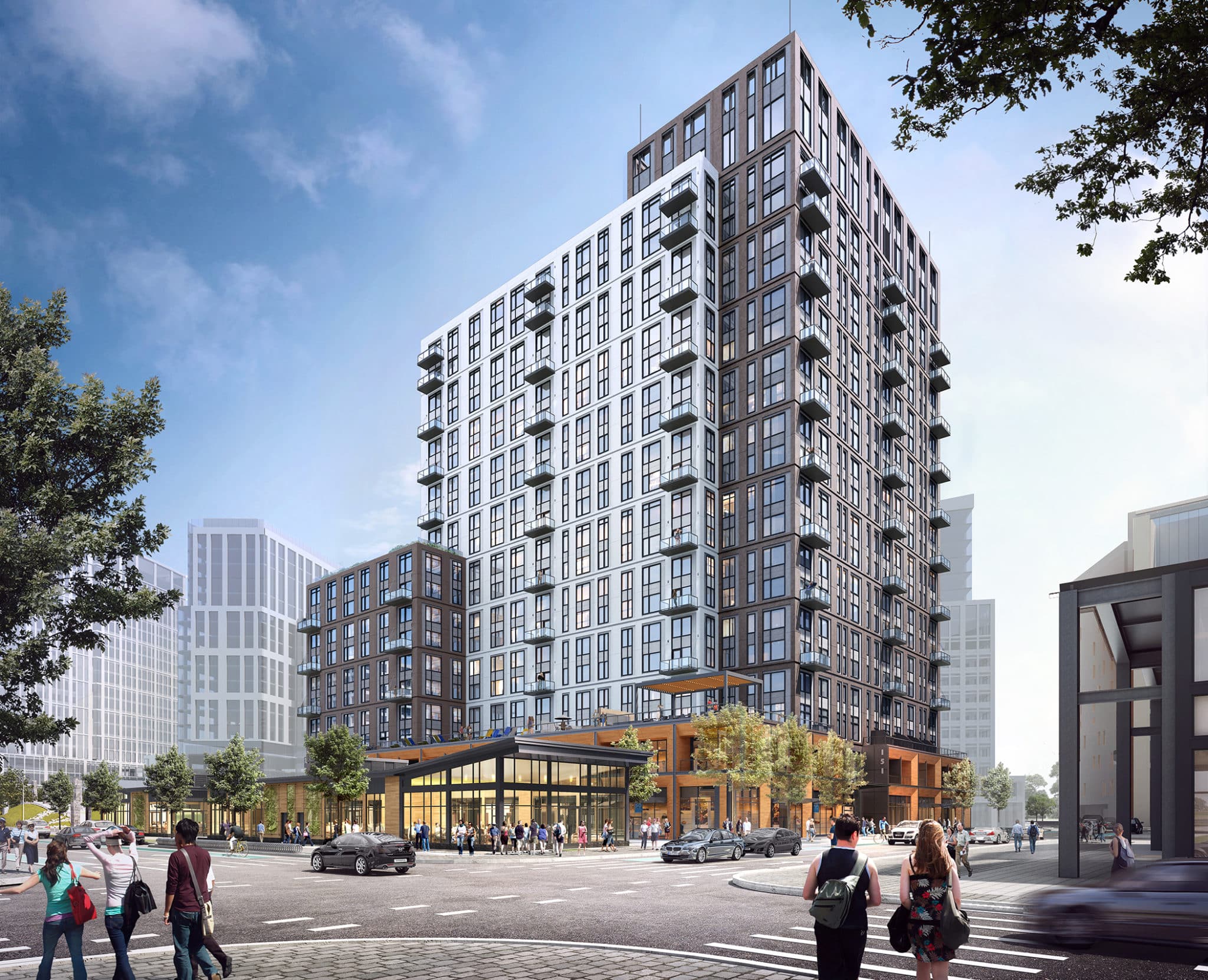 Pedestrians cross street near modern high-rise building with glass façade and retail space below