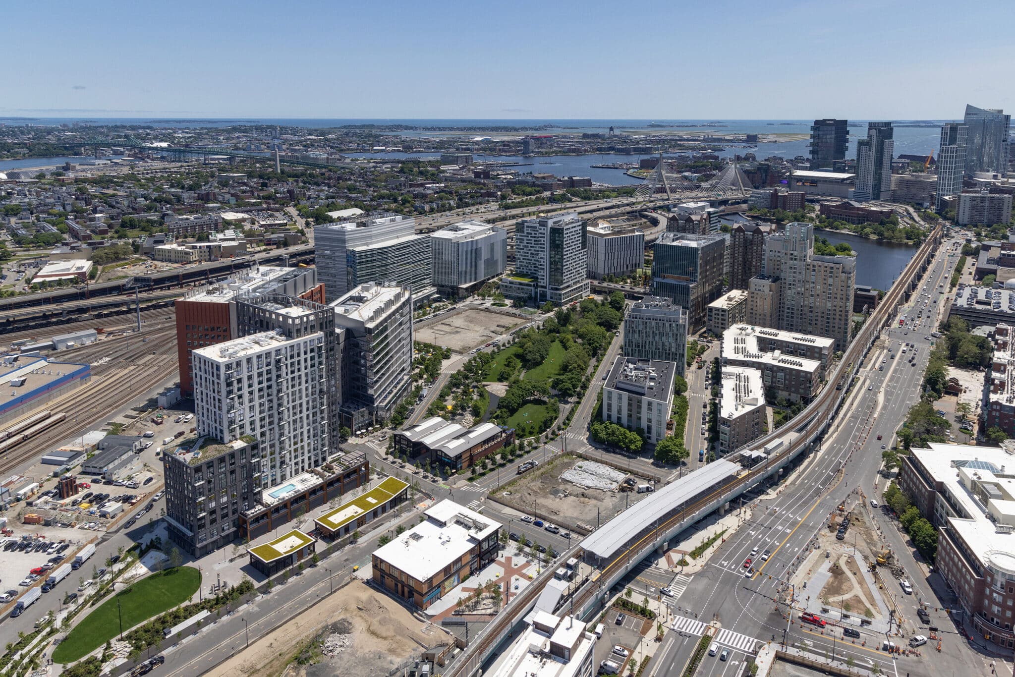 Expansive aerial view of Cambridge Crossing showing development, park spaces, and Boston skyline