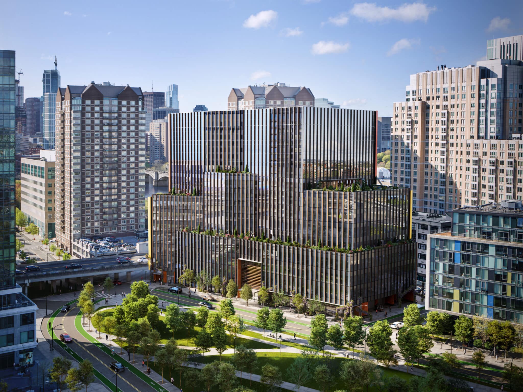 Daytime aerial view of tiered glass office building surrounded by downtown city high-rises