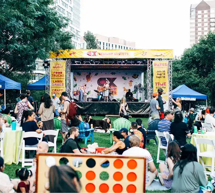 Colorful summer concert in city park with live band, food trucks, and vibrant community