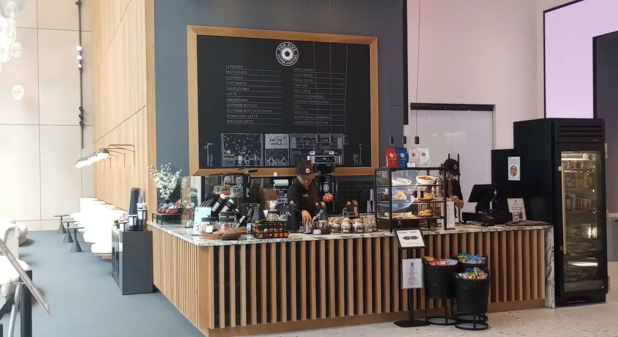 Contemporary retail building featuring glass walls and wood paneling in an urban district