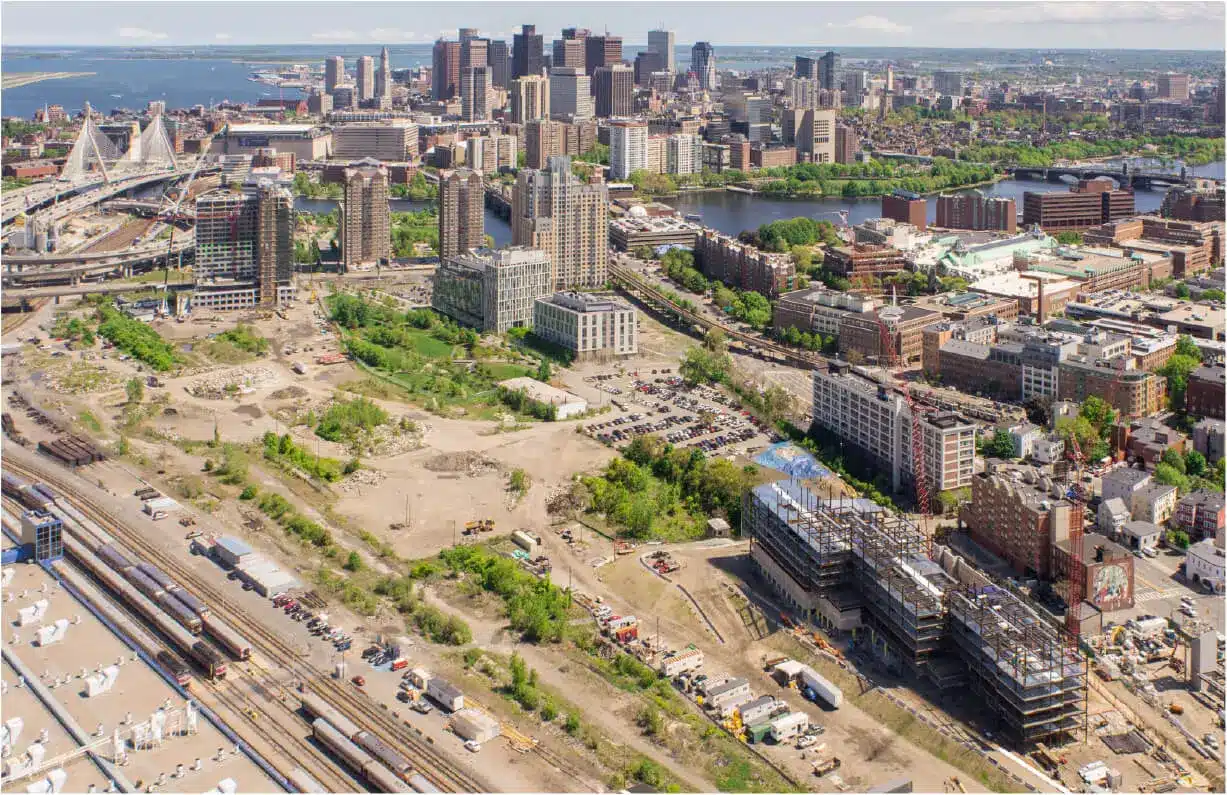 Aerial view of Cambridge Crossing construction site and surrounding cityscape including Charles River