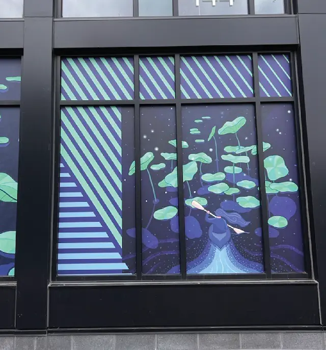 Illustrated storefront design featuring nature-inspired pattern with cosmic background and green leaves