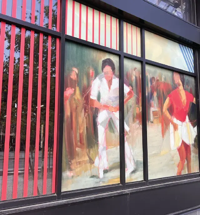 Artistic window painting capturing vibrant street dance scene with background figures and energy