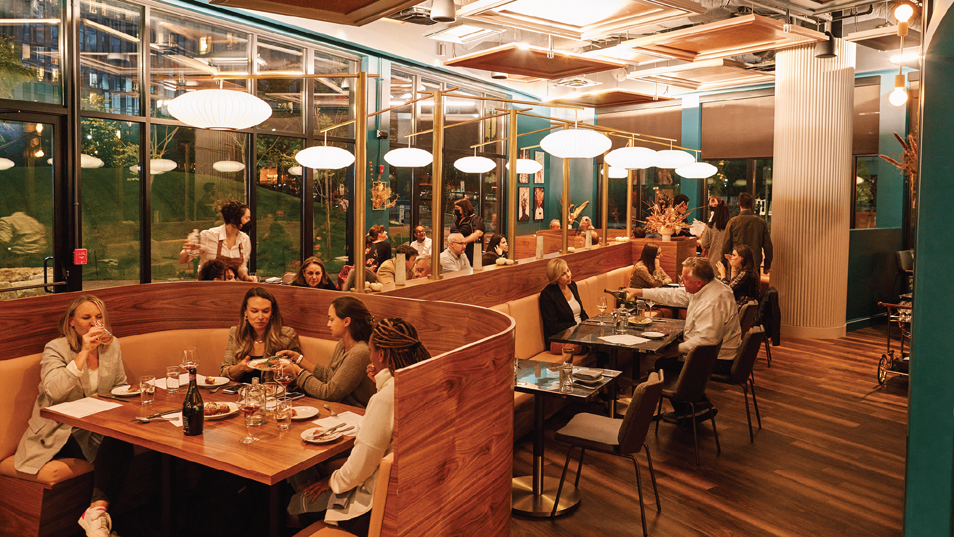 Geppetto - Elegant restaurant interior with modern wood booths and stylish pendant lighting at Geppetto