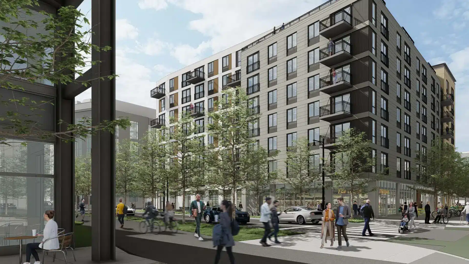 Mid-rise residential building with balconies, street-level retail, and pedestrians in urban setting