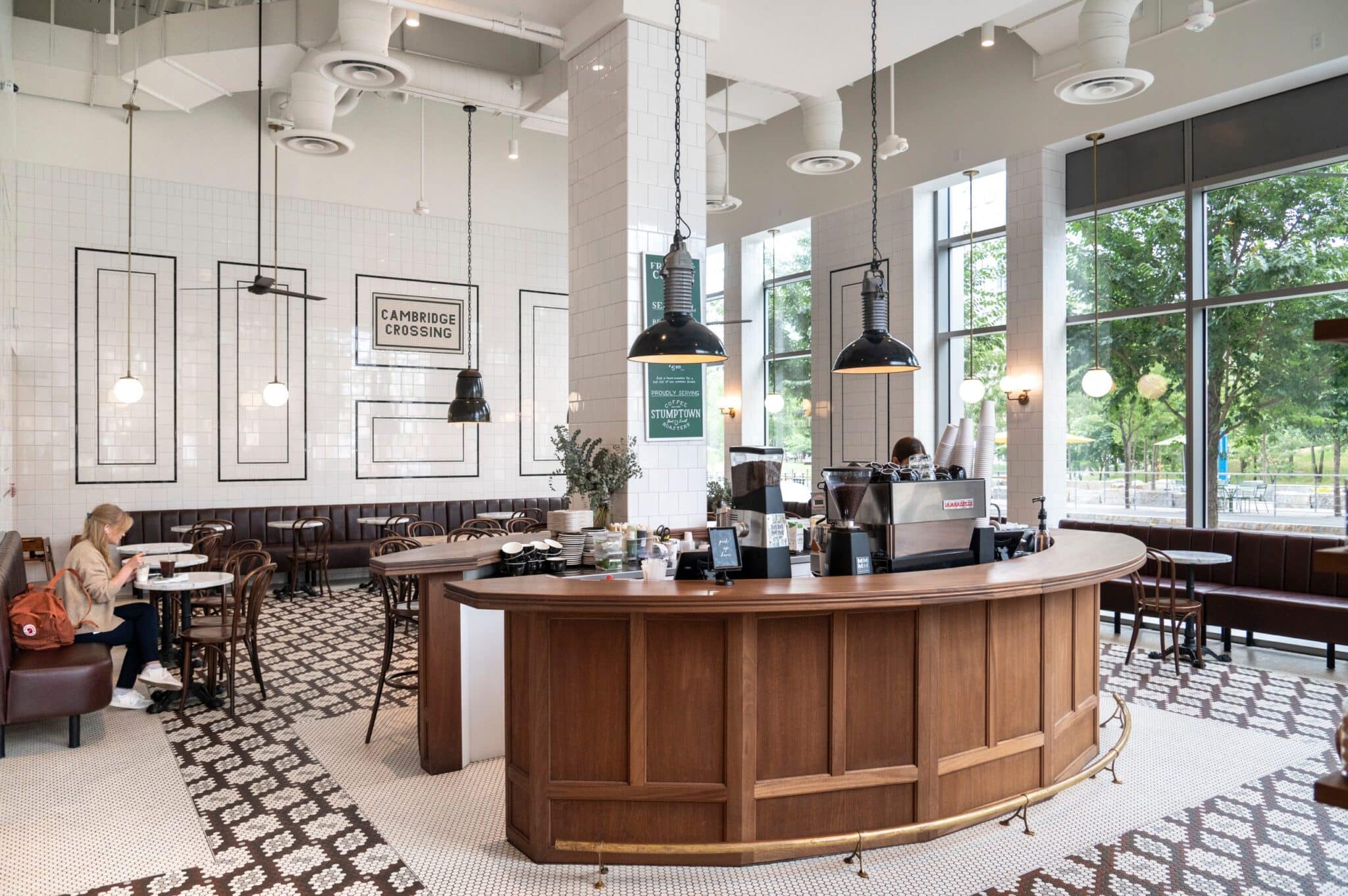 Tatte Cafe & Bakery - coffee shop with vintage tile flooring, wood-paneled counter, and large windows