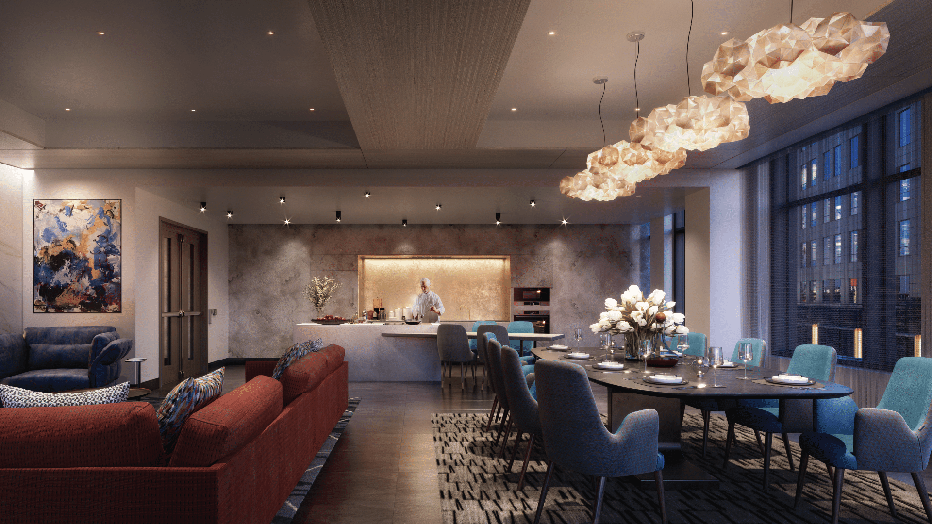 Luxurious dining lounge featuring round table, tulip centerpiece, and chef in open demonstration kitchen