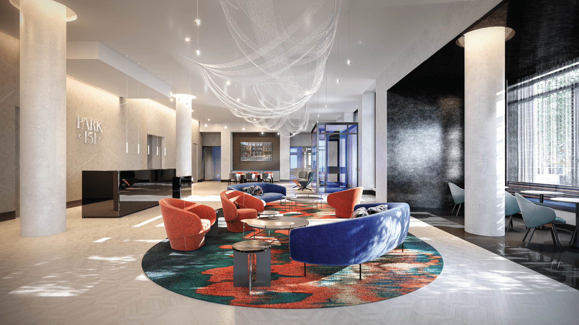 Bright residential lobby with bold furniture, art-inspired carpeting, and sculptural ceiling installation